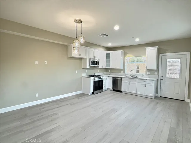a view of white cabinets and wooden floor