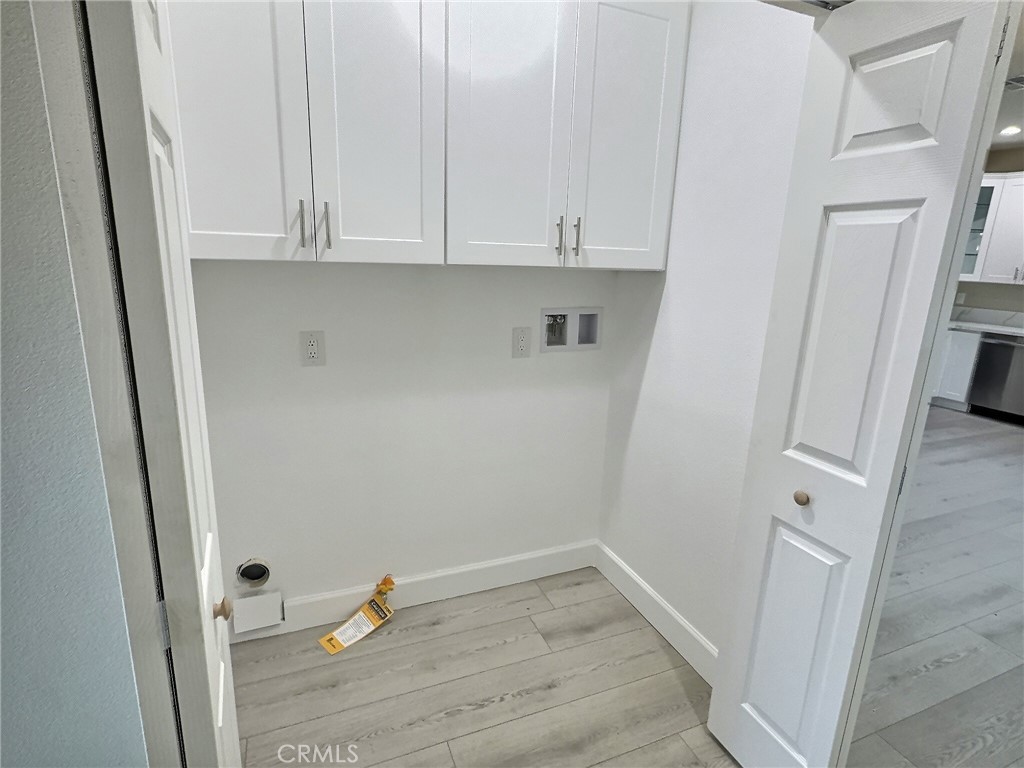 15909 Merrill Avenue, Unit 1 Fontana, CA 92335 - Photo 4 of 7 a view of white cabinets and wooden floor