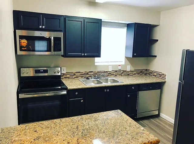 a kitchen with a stove and a microwave