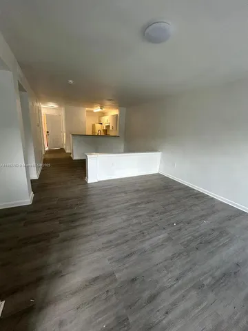 a view of a room with wooden floor
