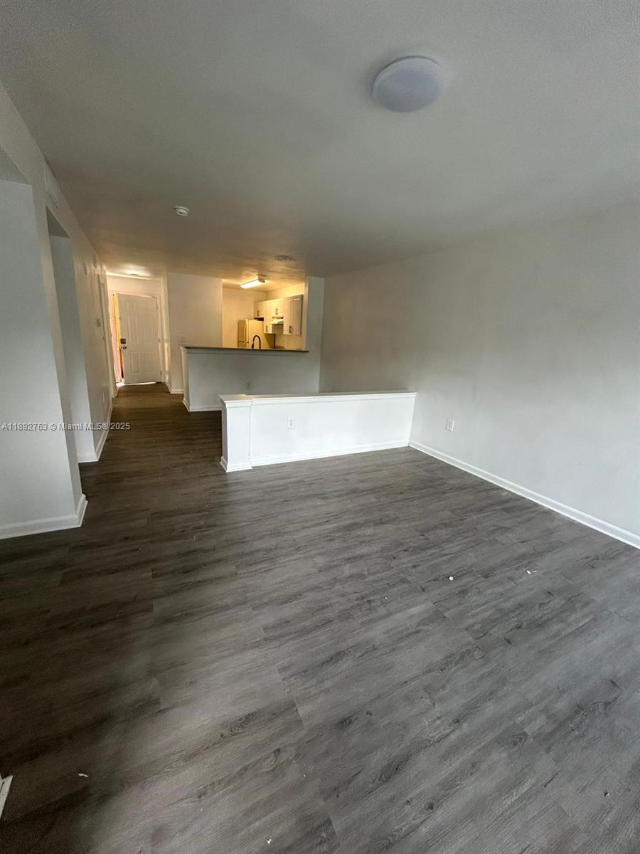 4815 Via Palm Lakes, Unit 1411 West Palm Beach, FL 33417 - Photo 2 of 11 a view of a room with wooden floor