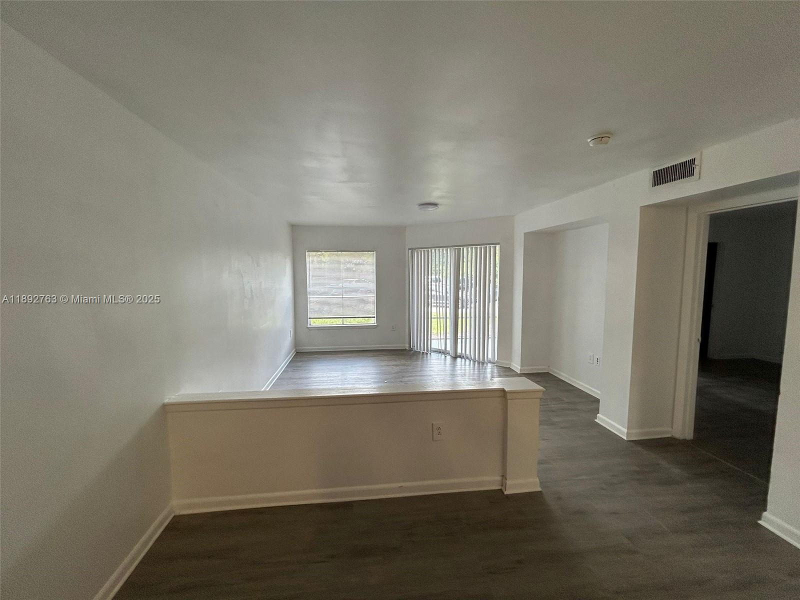 4815 Via Palm Lakes, Unit 1411 West Palm Beach, FL 33417 - Photo 3 of 11 an empty room with windows