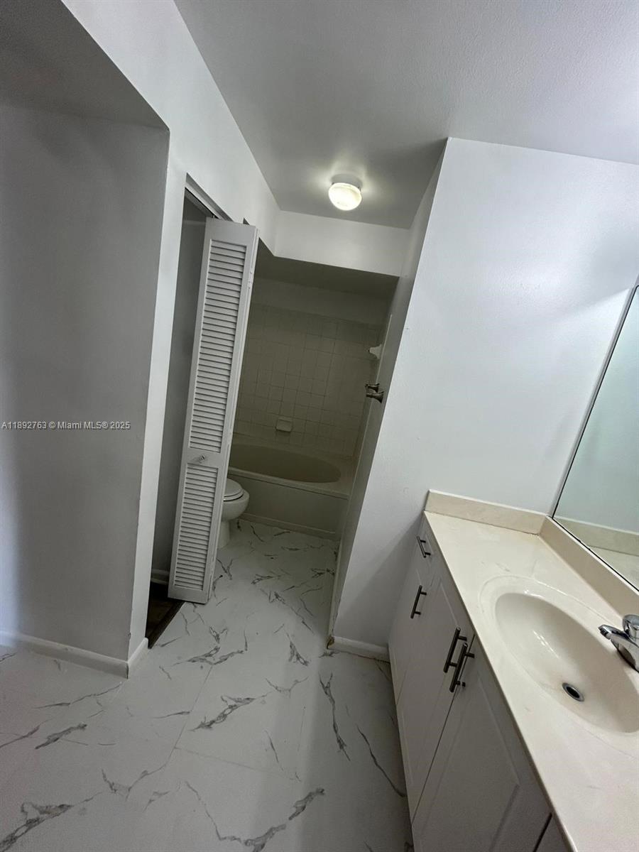 4815 Via Palm Lakes, Unit 1411 West Palm Beach, FL 33417 - Photo 8 of 11 a view of a storage & utility room with a sink