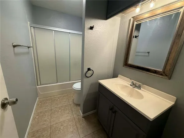 a bathroom with a sink a mirror and a shower