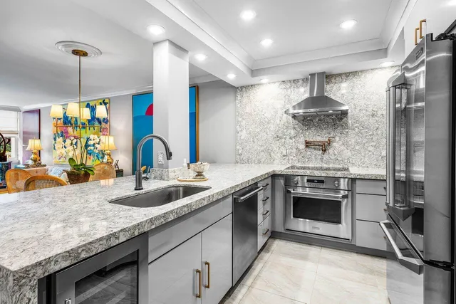 a kitchen with stainless steel appliances granite countertop a sink and stove