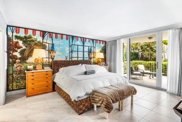 a bedroom with a bed and large window