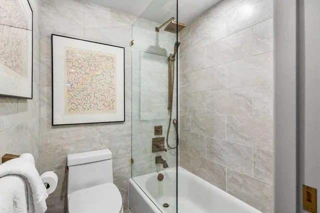 a bathroom with a toilet and a shower