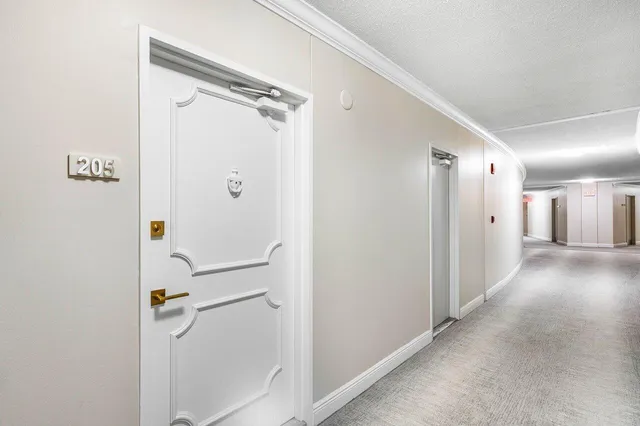 a living room with furniture and flowers