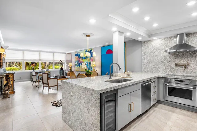 a kitchen with stainless steel appliances granite countertop a sink and a stove