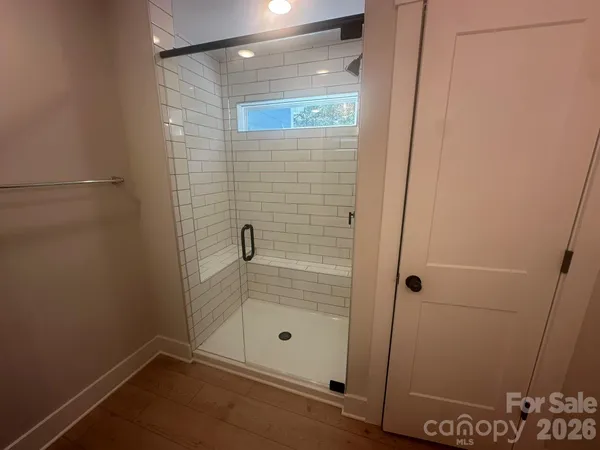 a bathroom with a glass shower door