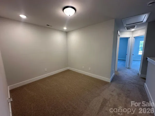 an empty room with closet and wooden floor