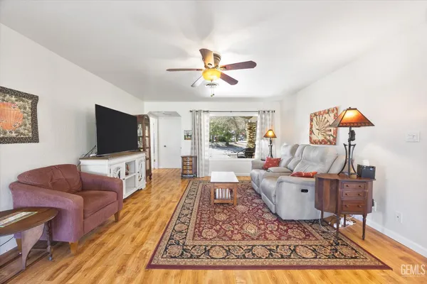 a living room with furniture and wooden floor