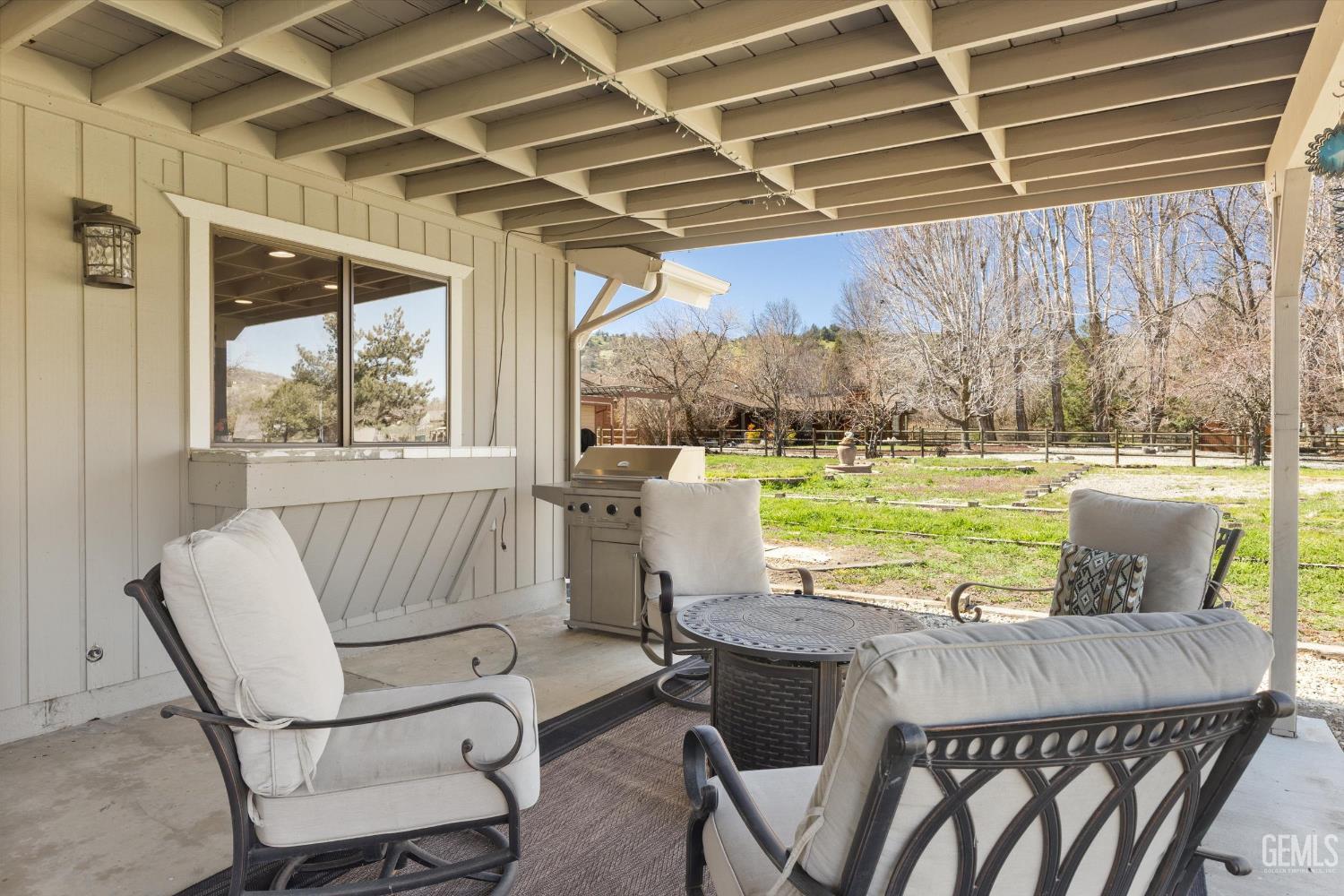 Undisclosed Address Tehachapi, CA 93561 - Photo 35 of 48 a view of a patio with a table chairs and a swimming pool