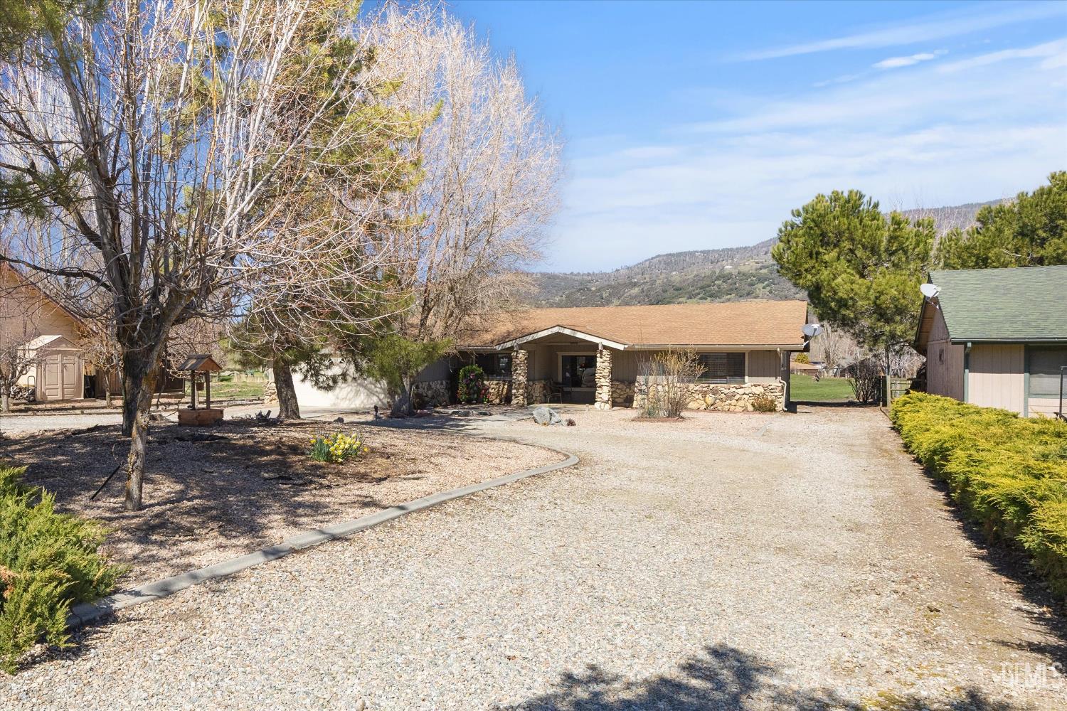 Undisclosed Address Tehachapi, CA 93561 - Photo 5 of 48 a front view of a house with a yard and large tree