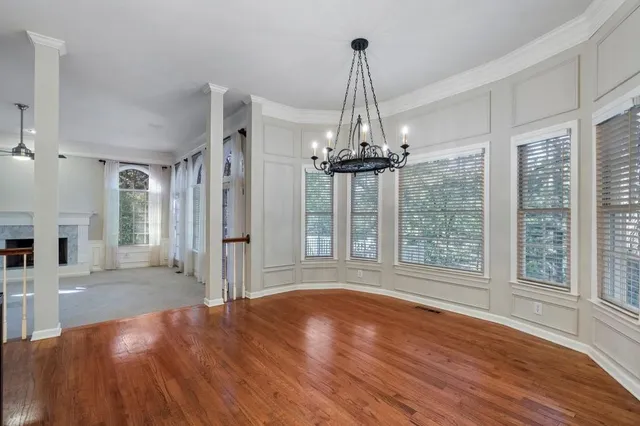 a view of empty room with wooden floor and outdoor view