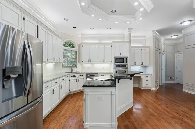 a kitchen with stainless steel appliances granite countertop a refrigerator oven stove a sink and a refrigerator