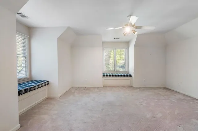 a kitchen with wooden floors and wooden cabinets