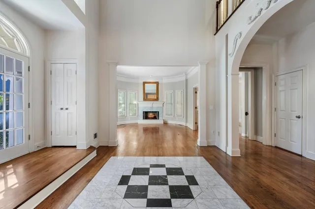 a view of a hallway with wooden floor and cabinet