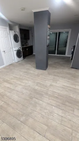 a room with a washing machine and a wooden floor