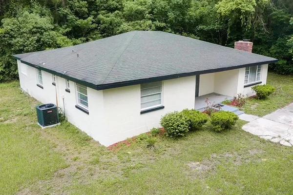 a aerial view of a house with a yard and garage