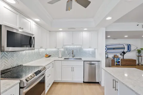 a kitchen with a sink stove and microwave