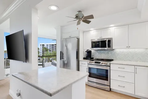 a kitchen with stainless steel appliances a stove microwave and refrigerator