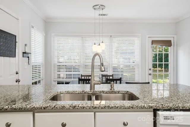 a kitchen with granite countertop a sink and a window