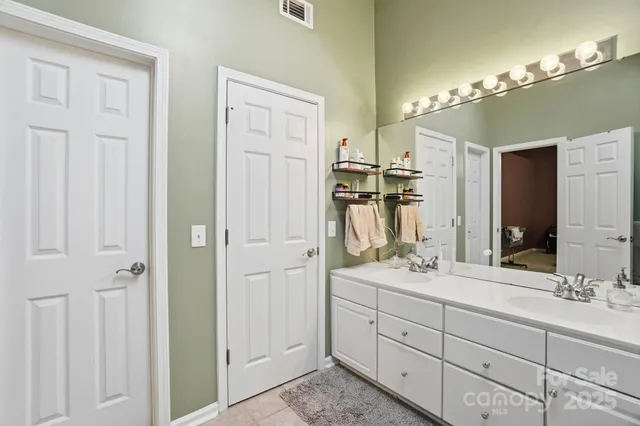 a bathroom with a double vanity sink and a mirror