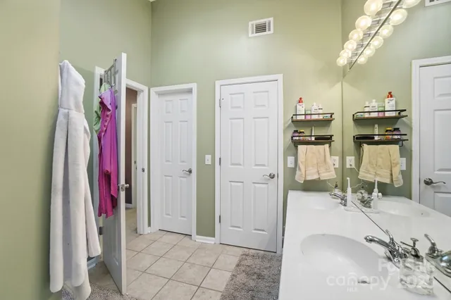 a bathroom with a sink vanity and a mirror