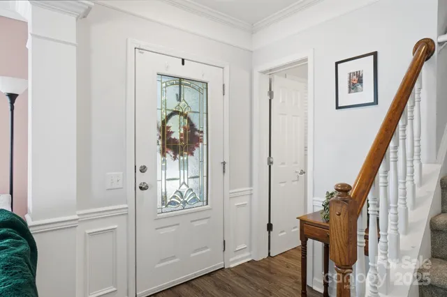 a view of a hallway with wooden floor and entryway