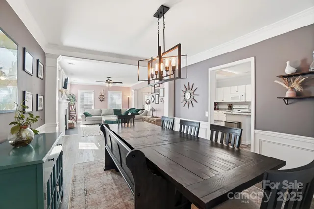 a dining room with furniture and wooden floor