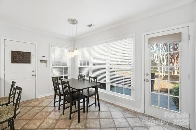 a view of a dining room with furniture and windows