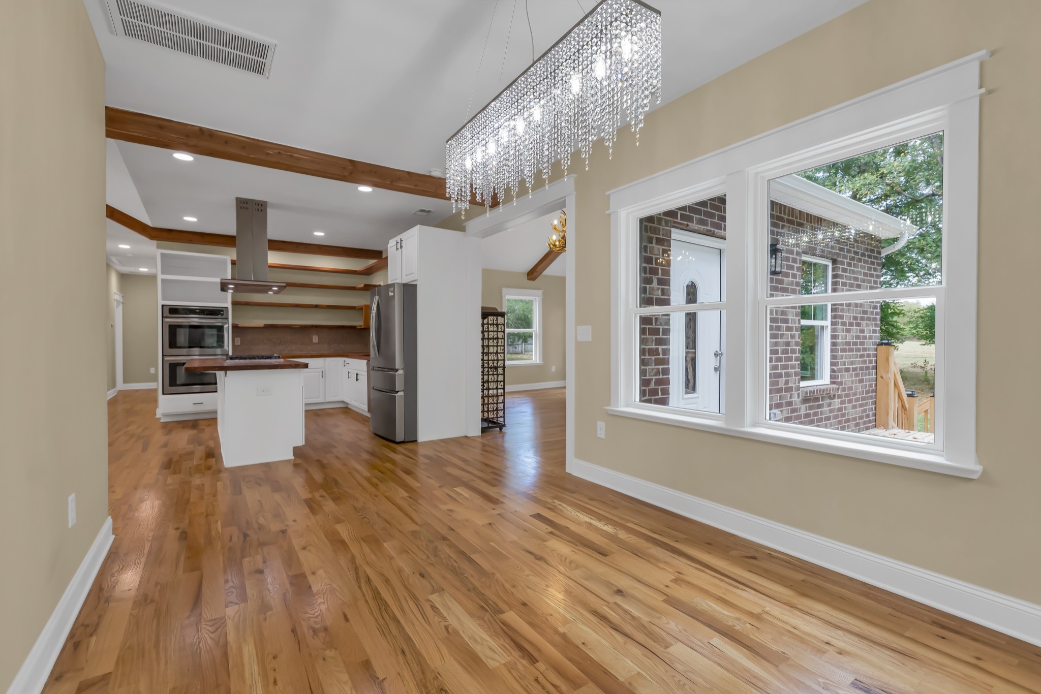 2250 Wayne Road Bon Aqua, TN 37025 - Photo 22 of 48 a view of a room with wooden floor and a kitchen