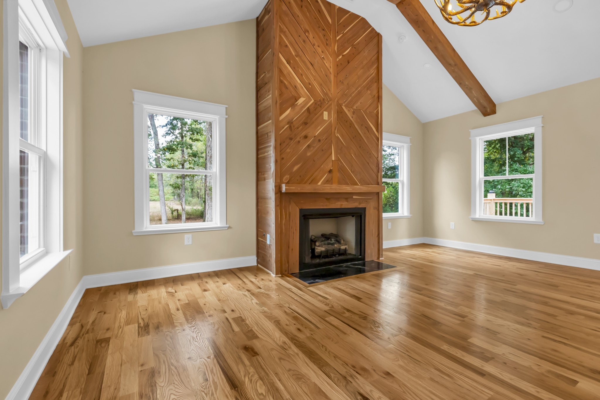 2250 Wayne Road Bon Aqua, TN 37025 - Photo 24 of 48 an empty room with windows a fireplace and wooden floor