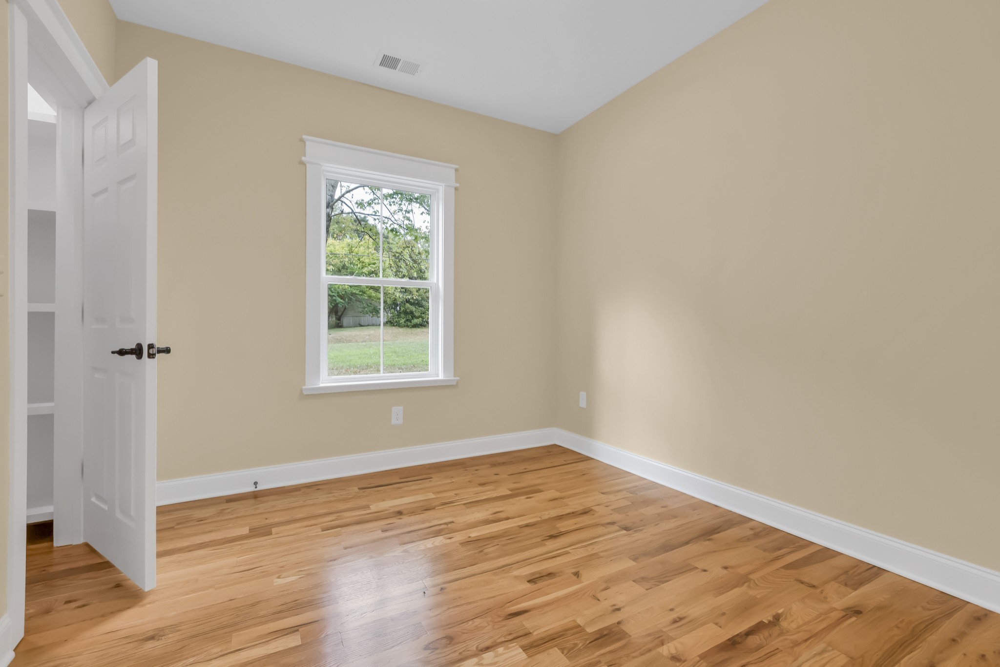 2250 Wayne Road Bon Aqua, TN 37025 - Photo 32 of 48 an empty room with wooden floor and a window