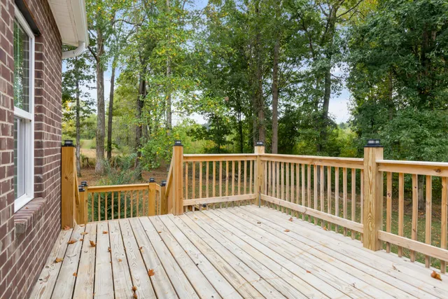 a view of balcony with wooden floor and fence