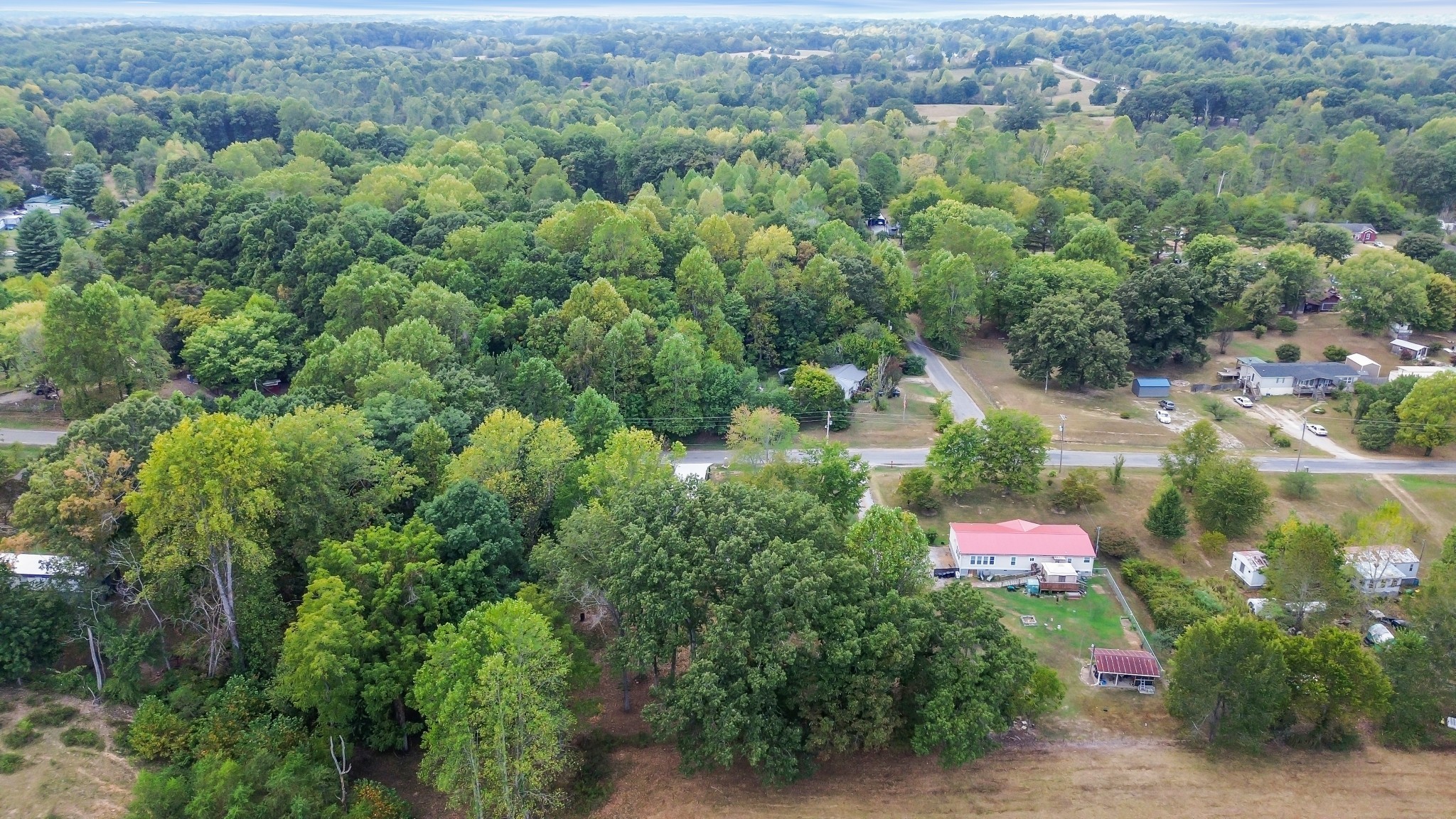 2250 Wayne Road Bon Aqua, TN 37025 - Photo 45 of 48 an aerial view of a red and white house with a yard and lake view
