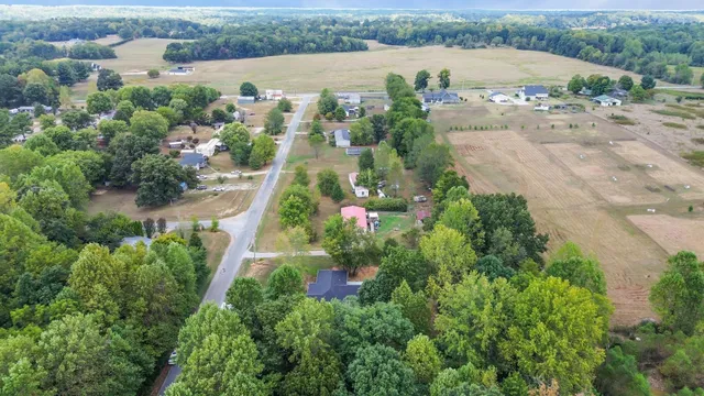an aerial view of lake residential house with outdoor space and trees around
