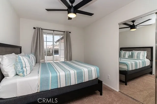 a bedroom with a bed next to a window