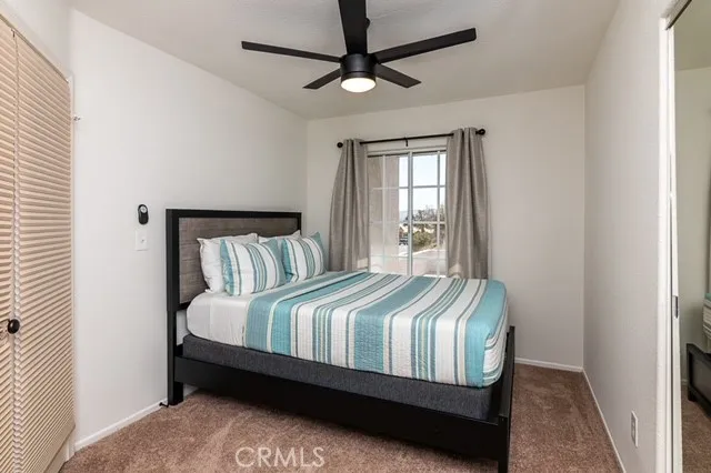 a bed sitting in a bedroom next to a window