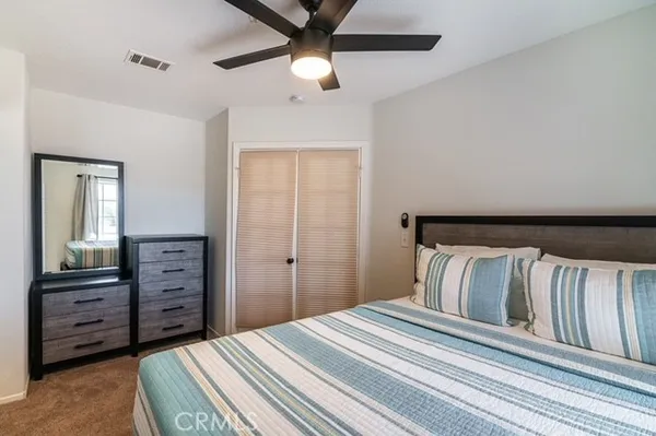 a bedroom with a bed and a dresser