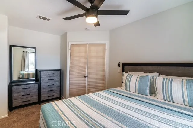 a bedroom with a bed and a dresser