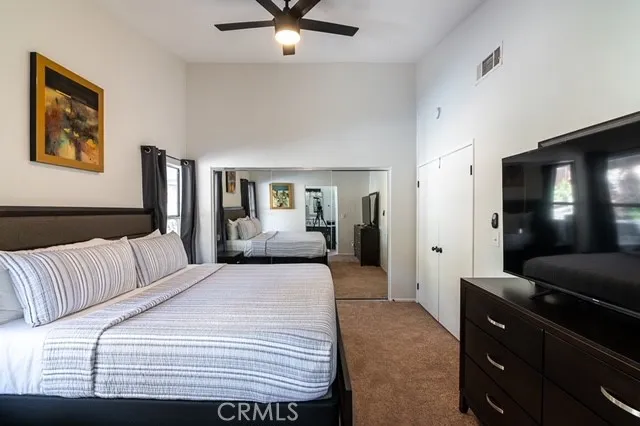 a bedroom with a bed and a mirror