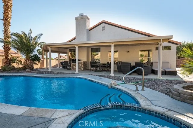 a view of a house with swimming pool and sitting area