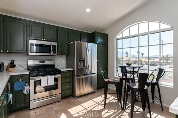 a kitchen with stainless steel appliances a stove a refrigerator and a microwave