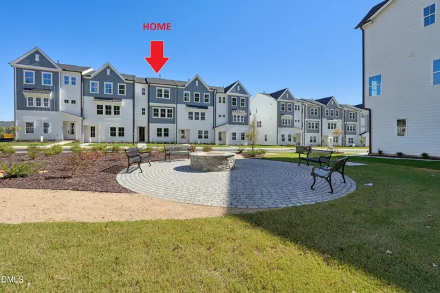 a bedroom with a large bed and a potted plant