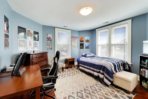 a bedroom with furniture and a window