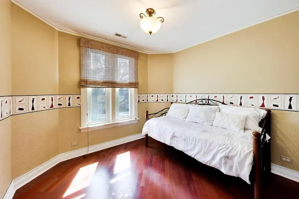 a spacious bedroom with a bed and a window