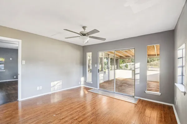 wooden floor in an empty room with a window