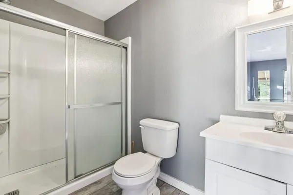a white toilet sitting next to a bathroom sink